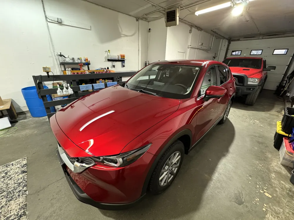Gleaming red Mazda in the shop after an exterior detail
