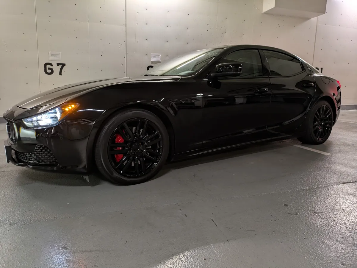 Black Maserati with a deep mirror finish after cut polishing